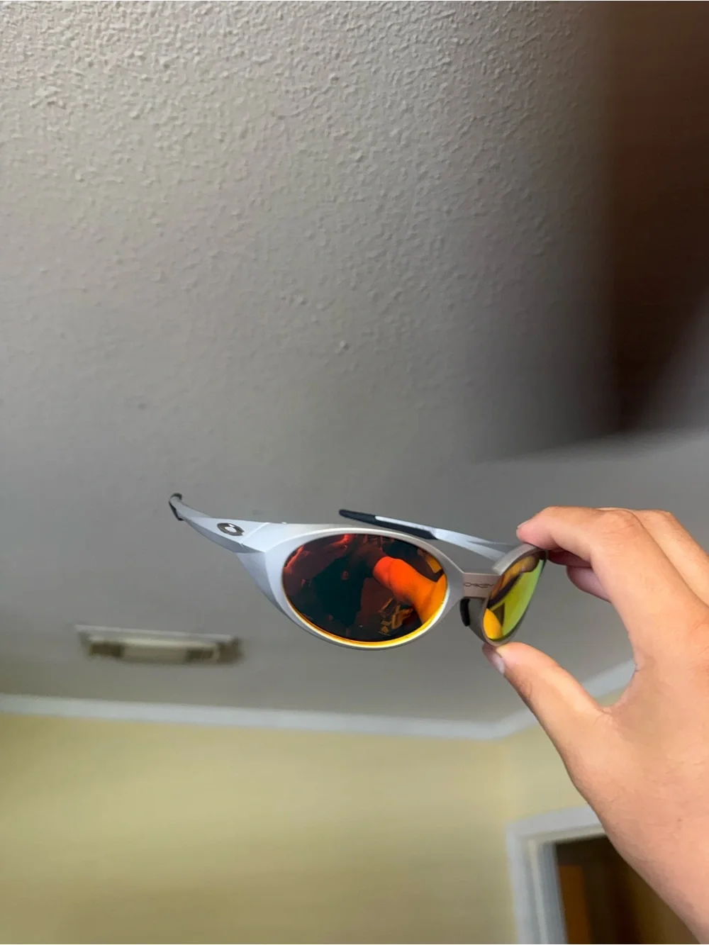Oakley Silver Frame Sunglasses with Orange/Yellow Mirrored Lenses Oakley